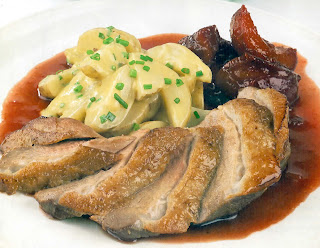 Classic recipe for a sliced roast breast of duck served with mashed potatoes and a spiced plum sauce.