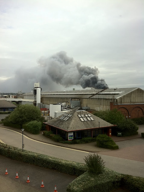 a building with a large smoke billowing from it