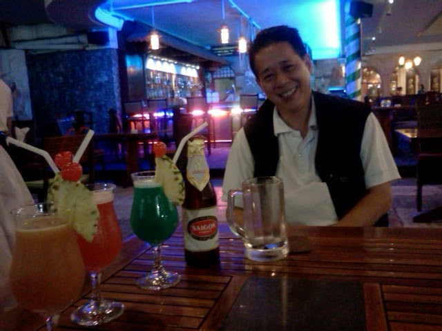 Panya with cocktails and beer at the Rex Hotel rooftop bar: Saigon Express, Singapore Sling and Saigon Beauty, plus Saigon lager beer. Panya with cocktails and beer at the Rex Hotel rooftop bar: Saigon Express, Singapore Sling and Saigon Beauty, plus Saigon lager beer.
