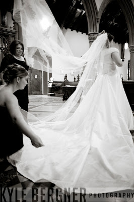 Matron of Honor straightening Bride's veil