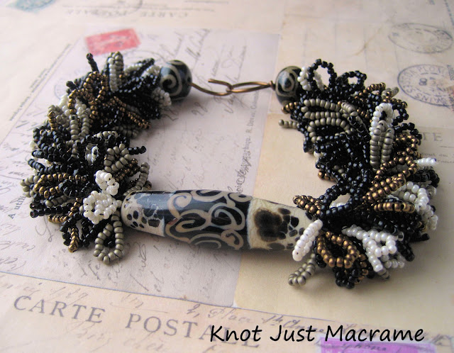 Handmade fringe bracelet by Sherri Stokey of Knot Just Macrame with Juli Cannon lampwork focal