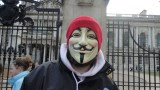 Masked Occupy Belfast protester outside Belfast City Hall