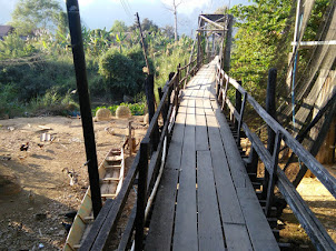 Narrow wooden pedestrian bridge in Vang Vieng Town.