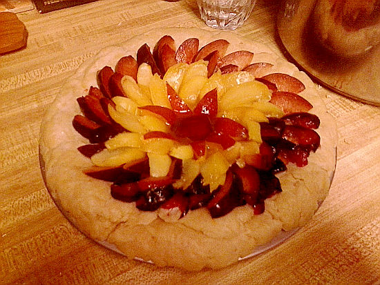 Beautiful German Tart covered with Nectarines, apricots, plums ready to pop in oven.