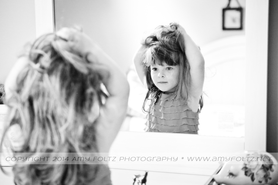 little girl looking in mirror