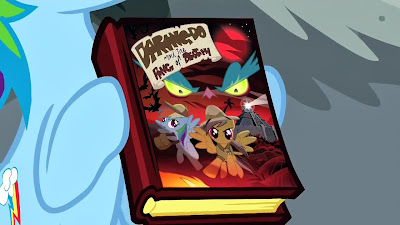 Rainbow Dash holds the new book