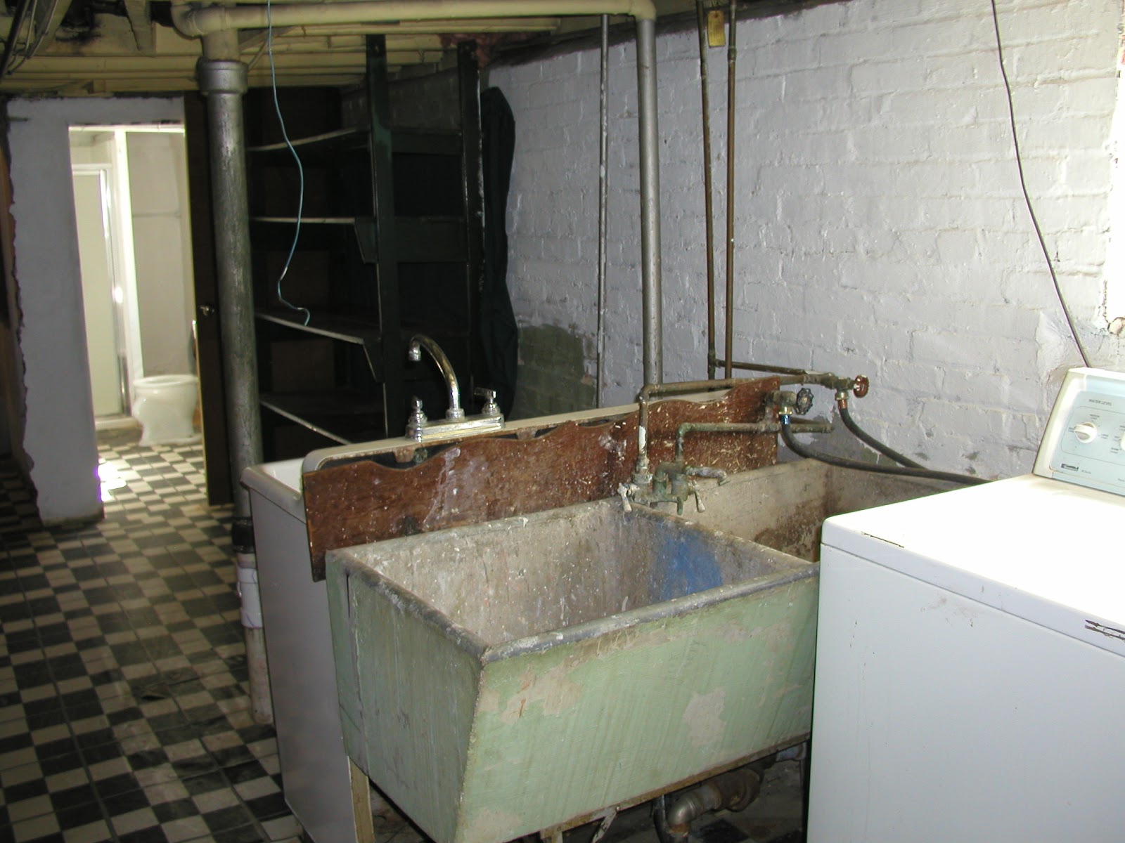 Before - Concrete laundry sink against regular sink