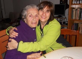 A daughter hugging her elderly mother. A daughter hugging her elderly mother.
