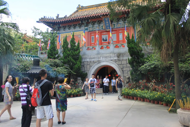 Paying respect to the God of Heaven with burning incense at Ngong Ping Village in Hong Kong Paying respect to the God of Heaven with burning incense at Ngong Ping Village in Hong Kong