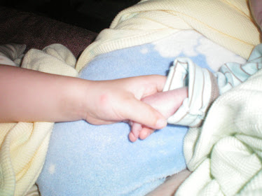 Harper holding his Baby Bro's hand