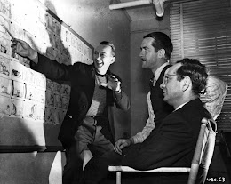 Eddie Selzer, foreground, with writer Warren Foster (at storyboard) and director Bob McKimson. From the Mike Barrier collection.