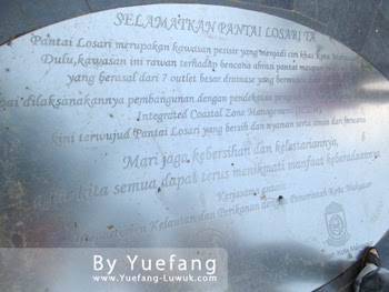 Standing on the "Save The Losari Beach" inscription standing_on_the_Losari_beach_inscription
