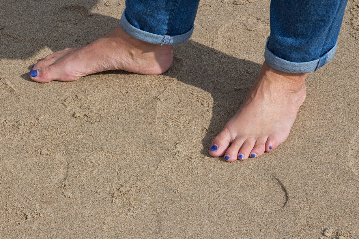woman's feet with blue nail polish