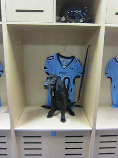 Coach is sitting in Austin's football locker bay with his #30 blue jersey behind him. Coach is sitting in Austin's football locker bay with his #30 blue jersey behind him.