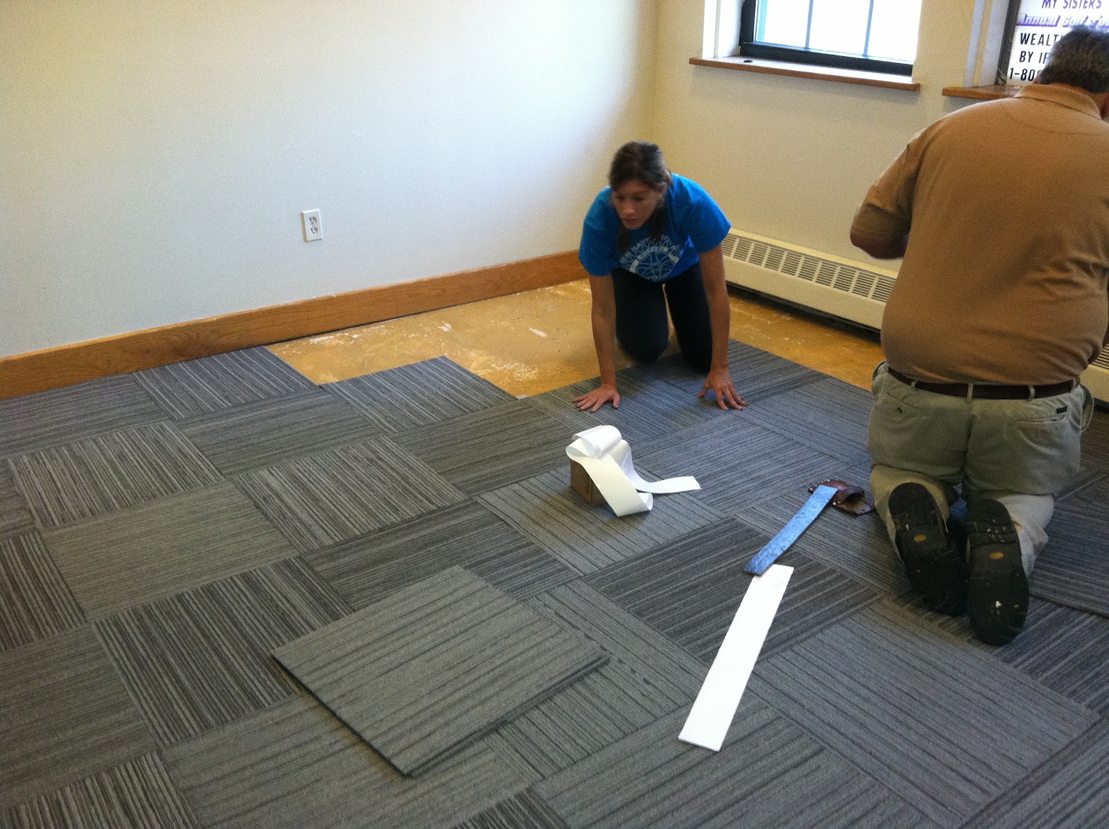 The Room Stylist Laying Carpet Tile at a Local Women & Children's Shelter