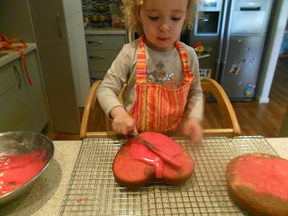 Spreading icing onto rainbow cake. Spreading icing onto rainbow cake.