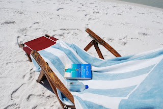 Stripe towel on beach chair Elin Hildebrand book Destin Florida