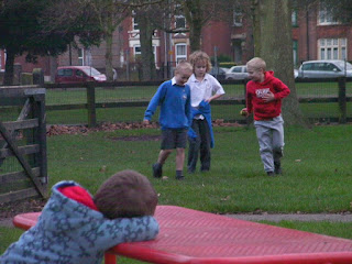 boys playing football in the park