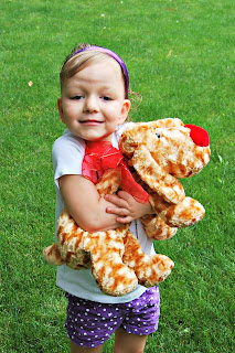 Toddler Girl Donating Toy Dog for Service Project