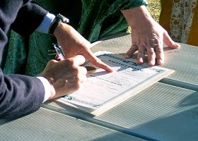 A man signing a contract. A man signing a contract.