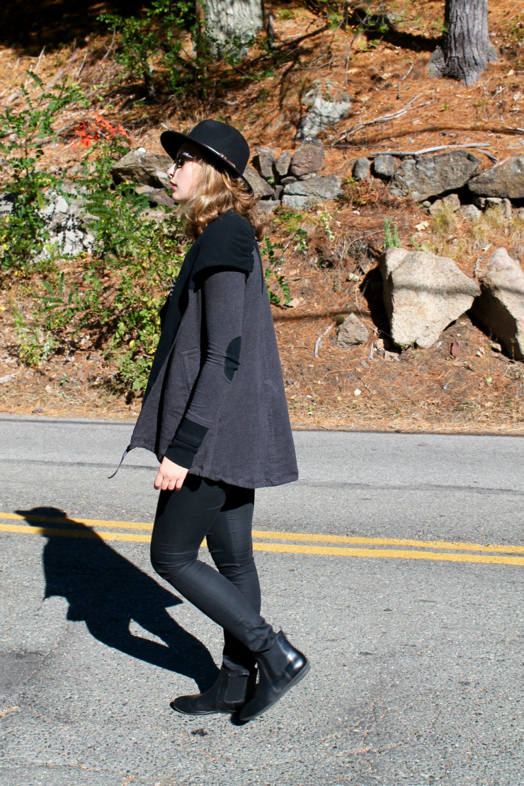 Black outfit with a Lululemon vest and fedora