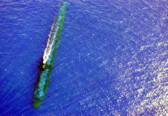 The US Navy's USS Chicago is at periscope depth off Malaysia in this July 24, 2001 photo USS Chicago (SSN 721)