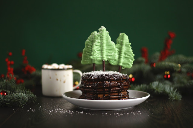 A Xmas special! Super chocolatey pancakes covered with fudgy chocolate sauce with chocolate trees and -  you guessed it - hot drinking chocolate! This festive recipe is brought to you by the German food blog Pancake Stories!