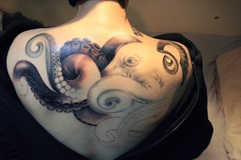 3D snail tattoo on back 