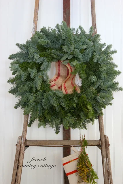 Christmas orchard ladder for hanging a wreath and stockings - gorgeous idea by French Country Cottage, featured on I Love That Junk