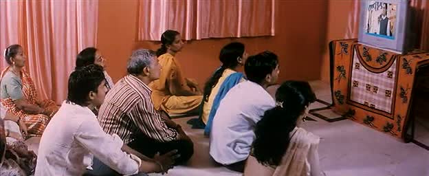 A group of random strangers watch TV A group of random strangers watch TV