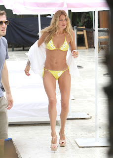 Doutzen Kroes shjows off her great body in a skimpy yellow Bikini