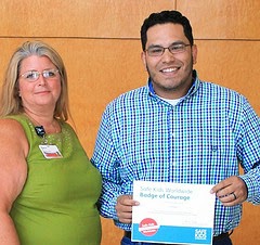 Safe Kids Coordinator Rene Hopkins, left, presents the Badge of Courage to Nick Ortalaza for rescuing a child from a hot vehicle. Photo: GRU