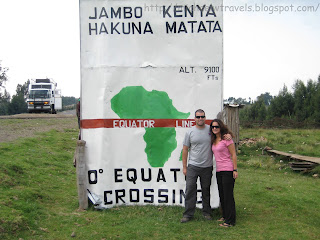 a man and woman standing in front of a sign