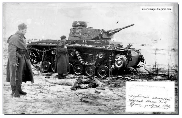 Russian soldiers examine wrecked German Panzer 3
