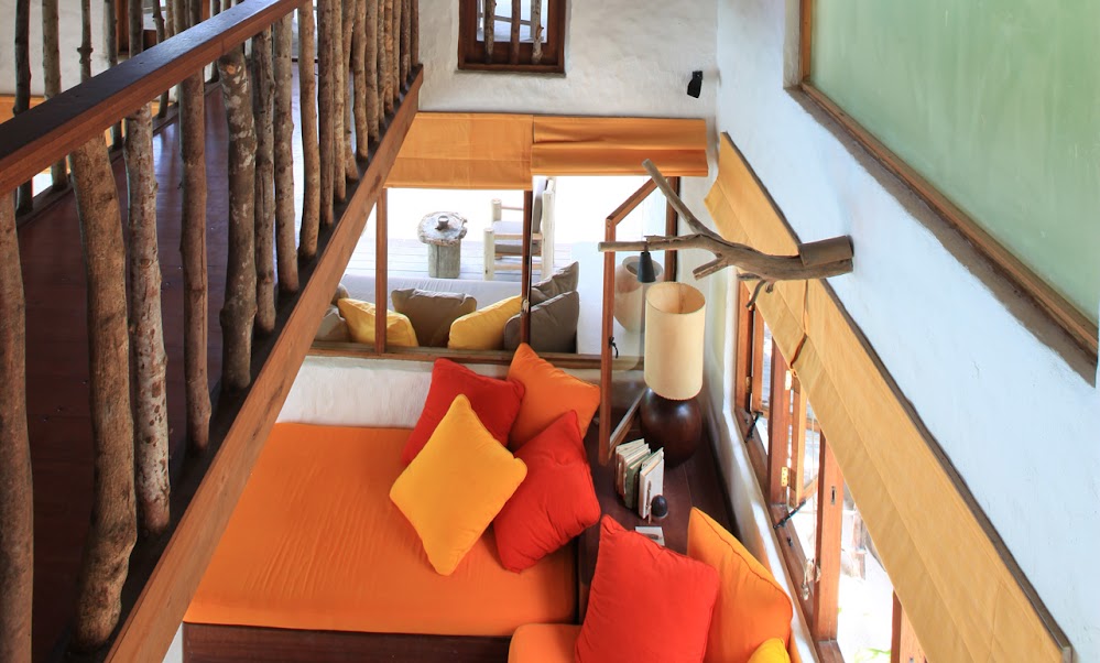Photo of pillows on the couch as seen from the upper level inside of one of the residences