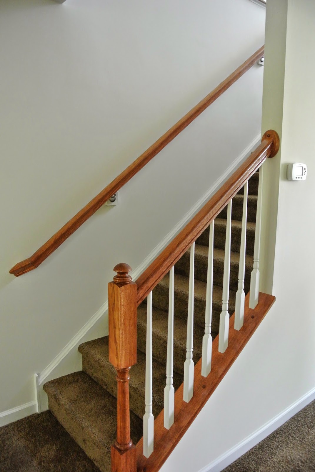 Ryan Homes Florence Model Finished Banister and Railing at bottom of stairway to the second floor A picture of the finished banister and railing at the bottom of the stairway to the second floor.