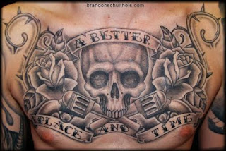 skull tattoo covering a men's chest skull and guns tattoo covering a men's chest