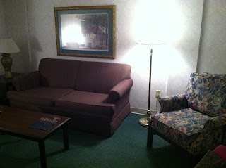 a living room with a couch and a lamp