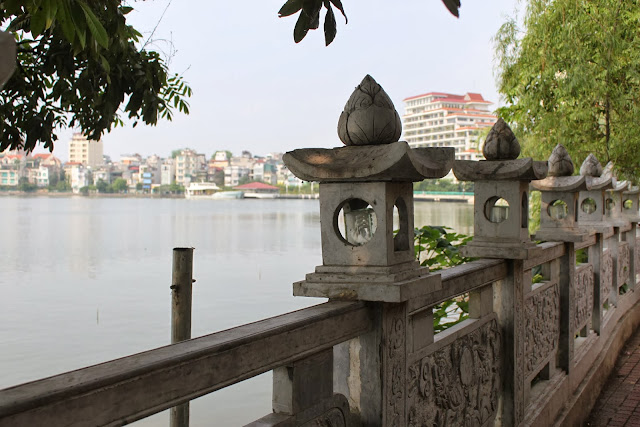 Enjoying the lake view and lotus lamp stand at the oldest pagoda of Tran Quoc Pagoda in Hanoi, Vietnam Enjoying the lake view and lotus lamp stand at the oldest pagoda of Tran Quoc Pagoda in Hanoi, Vietnam