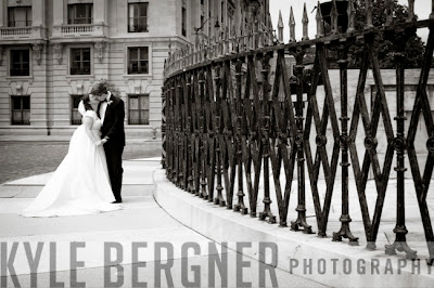 Bride and groom kissing next to Washington Monument in Mt Vernon Baltimore