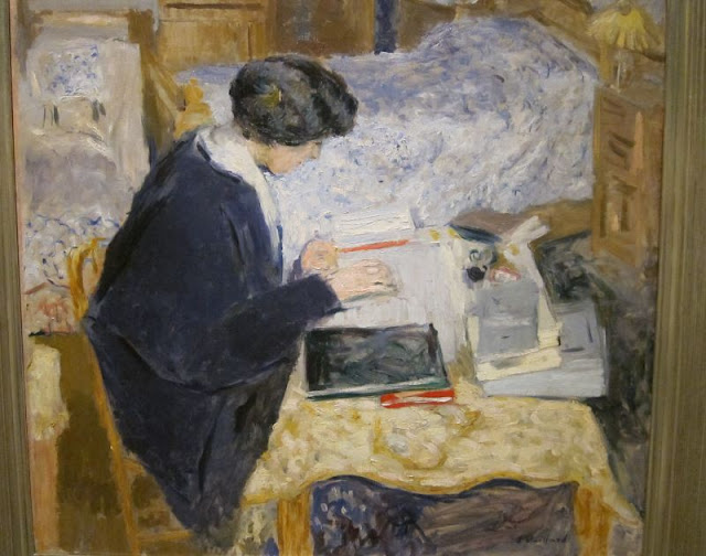 Woman writing at her desk seen overhead