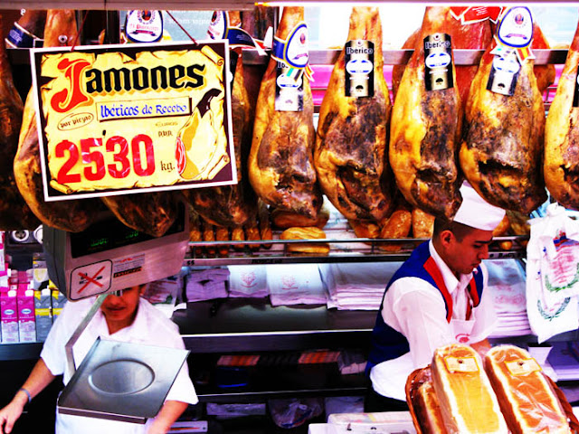 Delicious Iberian hams hanging in a restaurant & deli in Madrid, Spain.