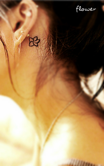 small flower tattoo behind ear
