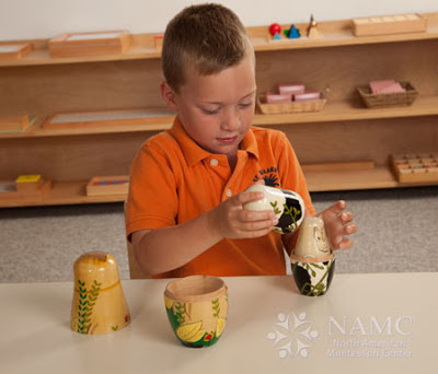 NAMC montessori whole to part lower elementary geography boy with nesting dolls