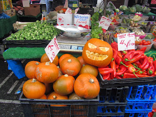 pile of pumpkins at a market stall