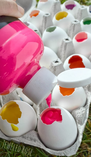 Fill eggs with paint and toss them at canvas!  This project is surprisingly easy to set up and SO FUN!