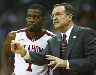 Lon Kruger head coach of Oklahoma Sooners talks with Sam Grooms #1 during a break in action against Texas A&M Aggies in the first round of the Big 12 Basketball Tournament March 7, 2012 at Sprint Center in Kansas City, Missouri. Texas A&M won 62-53. (March 6, 2012 - Source: Ed Zurga/Getty Images North America)