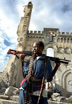 (After) A Muslim gunman proudly poses in front of the destroyed church building