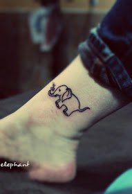a cute little elephant tattoo with its nose blowing water