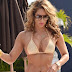 Jennifer Nicole Lee packs some Miami heat in a miniscule bikini which shows off her VERY curvy figure